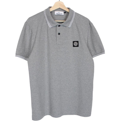 Stone Island grey polo shirt with embroidered compass logo and cotton material.