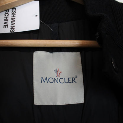 Moncler black suede leather down jacket with full zip and missing badge detail.