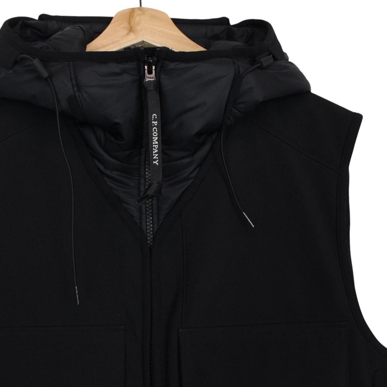 CP Company black goggle gilet with logo detail and shell material.
