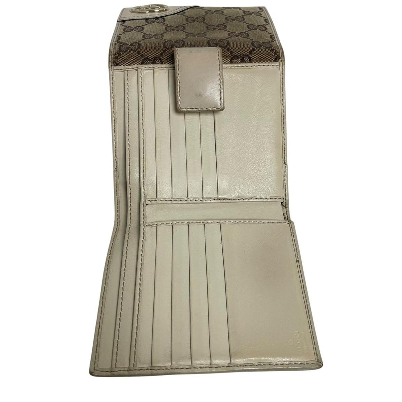 Gucci brown bifold wallet with Supreme monogram pattern and leather accents.
