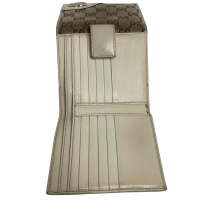 Gucci brown bifold wallet with Supreme monogram pattern and leather accents.