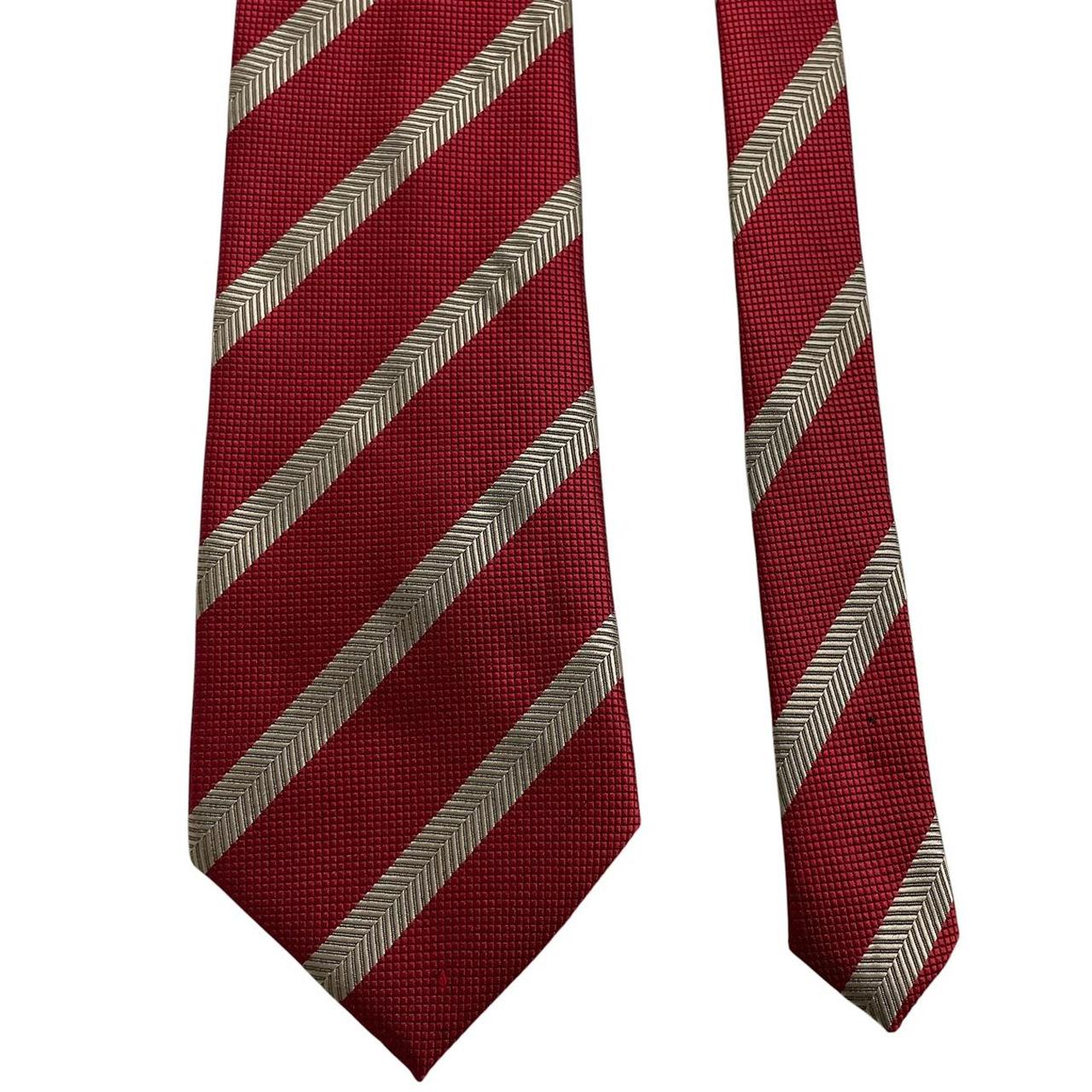 Hugo Boss red striped silk tie with subtle sheen and classic design.