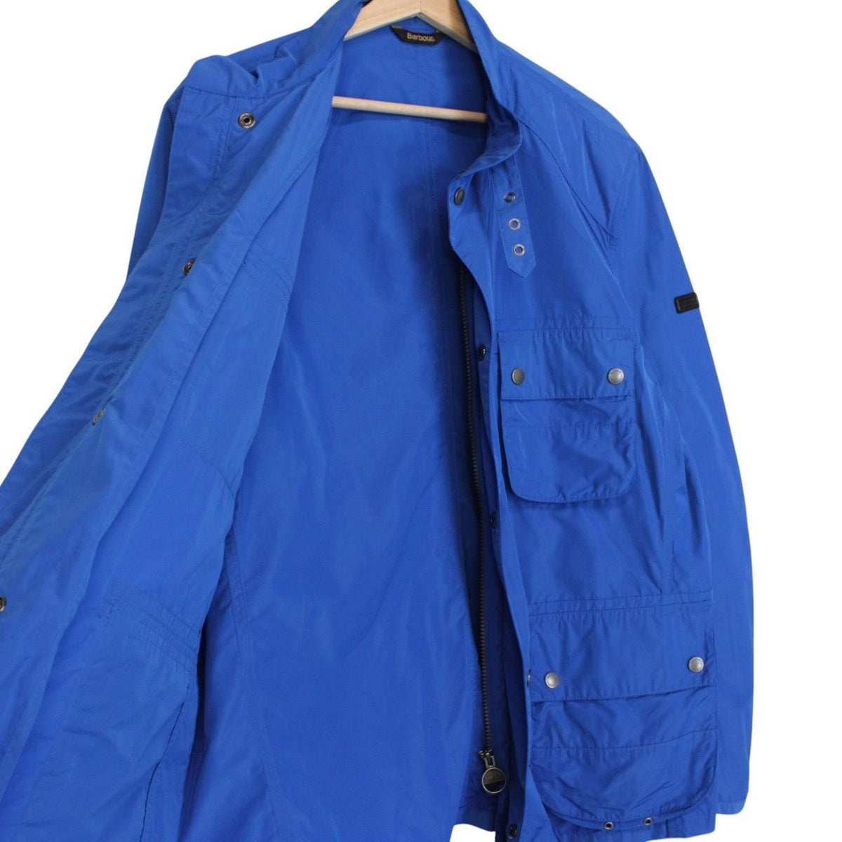 Barbour blue nylon multi-pocket jacket with logo detailing and scuff on bottom right pocket.