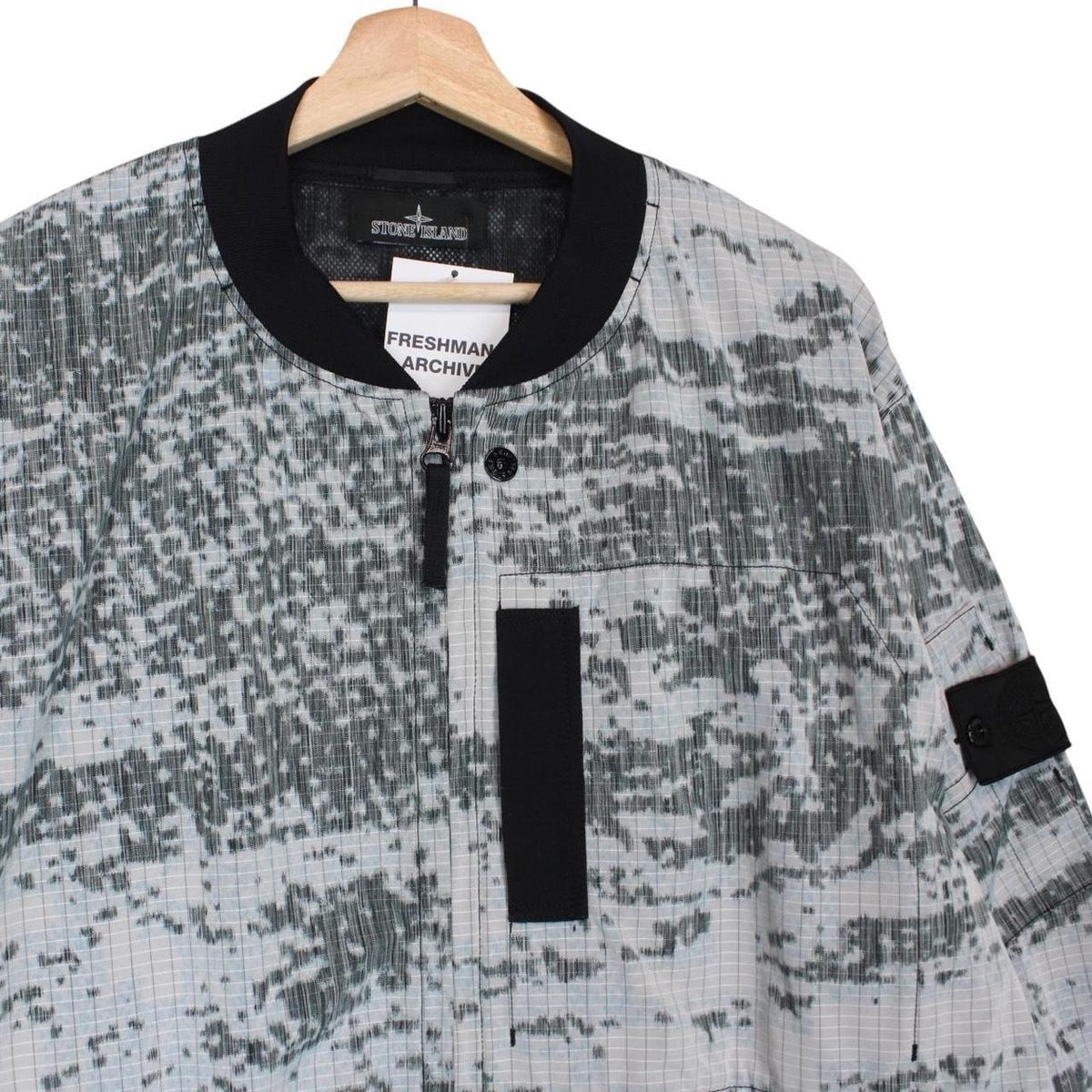 Stone Island bomber jacket grey marl with embroidered compass logo and unique pattern.