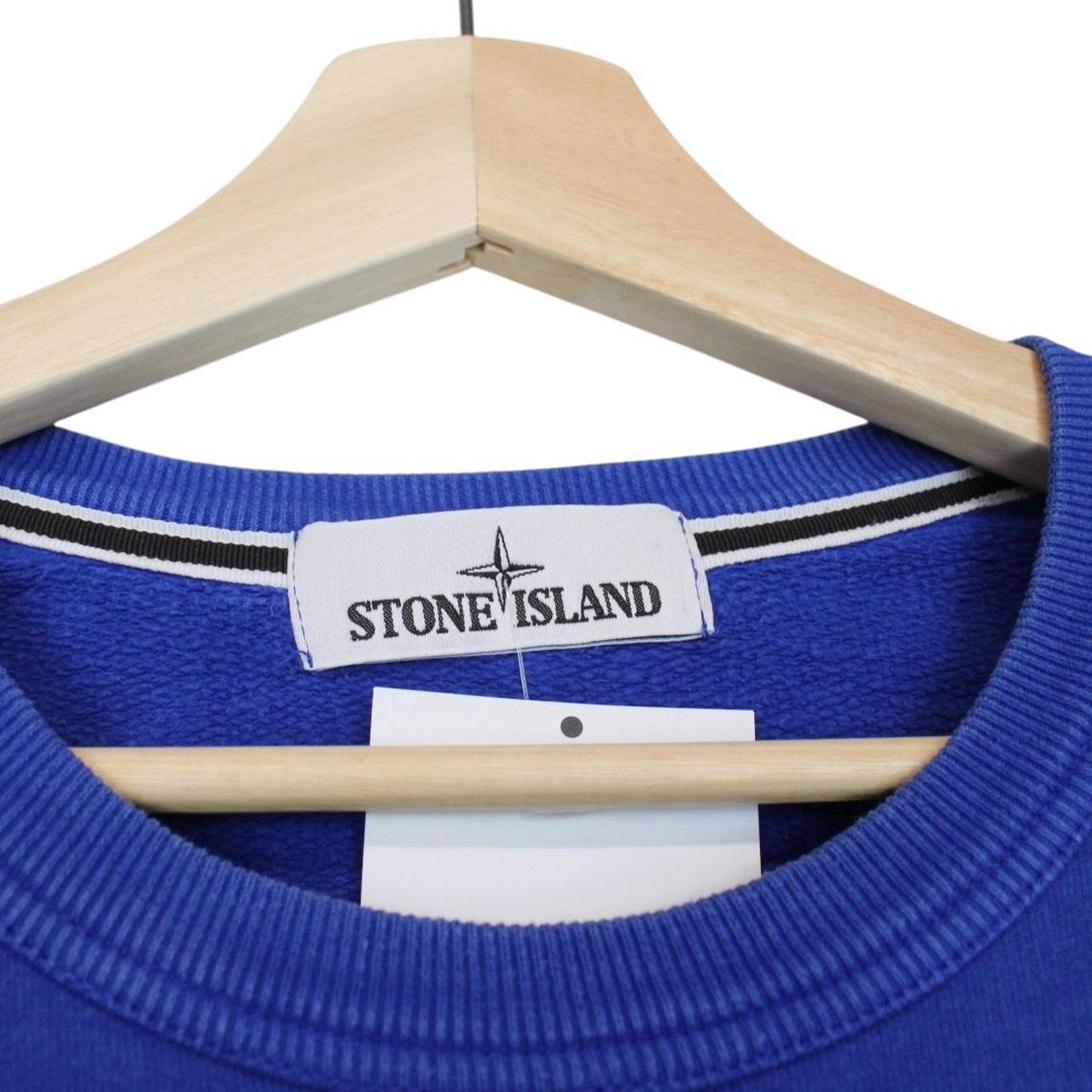 Stone Island blue cotton sweatshirt with logo patch and ribbed cuffs.