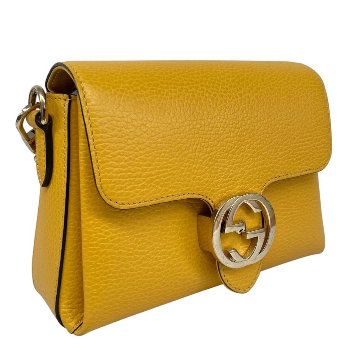 Gucci yellow leather crossbody bag with interlocking G logo and minor metal scratches.