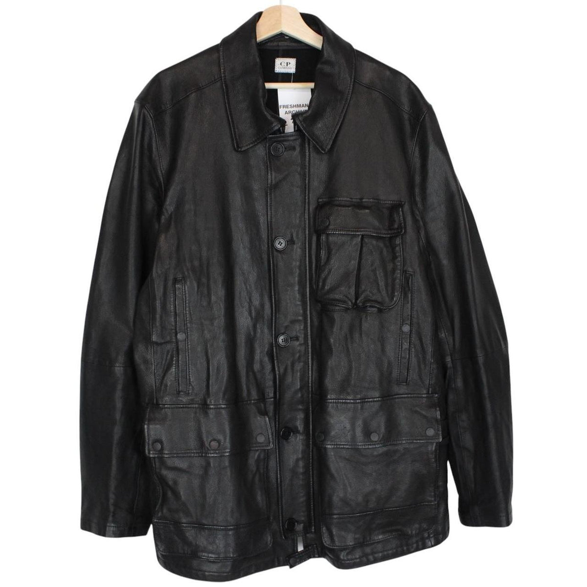 CP Company black leather jacket with multi pockets and logo detail.