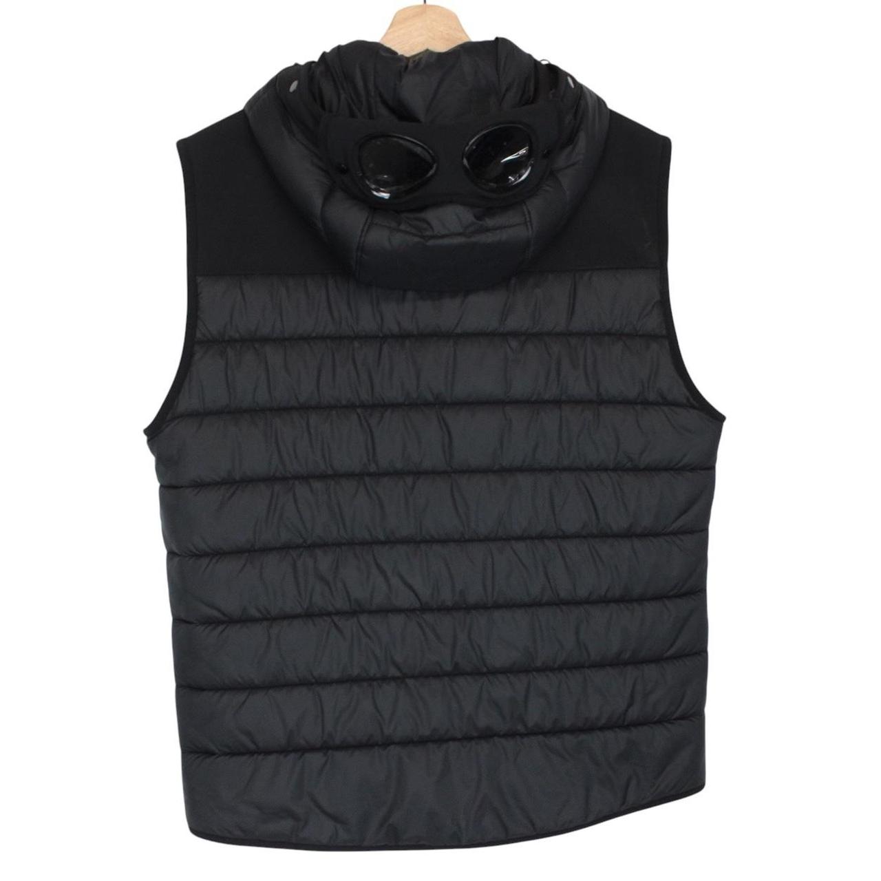 CP Company black goggle gilet with logo detail and shell material.