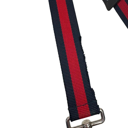 Gucci black duffel bag featuring GG Supreme monogram pattern and adjustable strap.