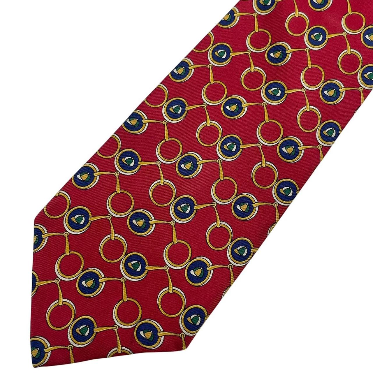 Burberry red silk tie featuring vintage horsebit print design.