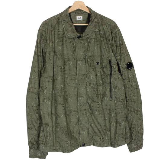 CP Company khaki green overshirt jacket with digital camouflage pattern and lens detail.