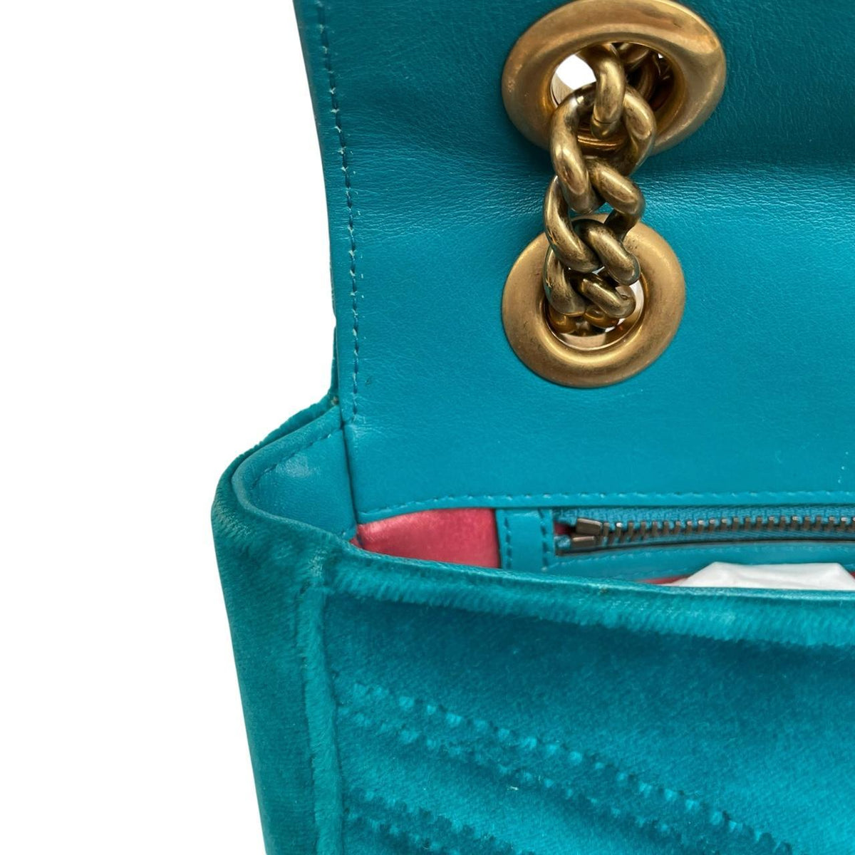 Gucci turquoise velvet shoulder bag with gold GG logo and green accents.