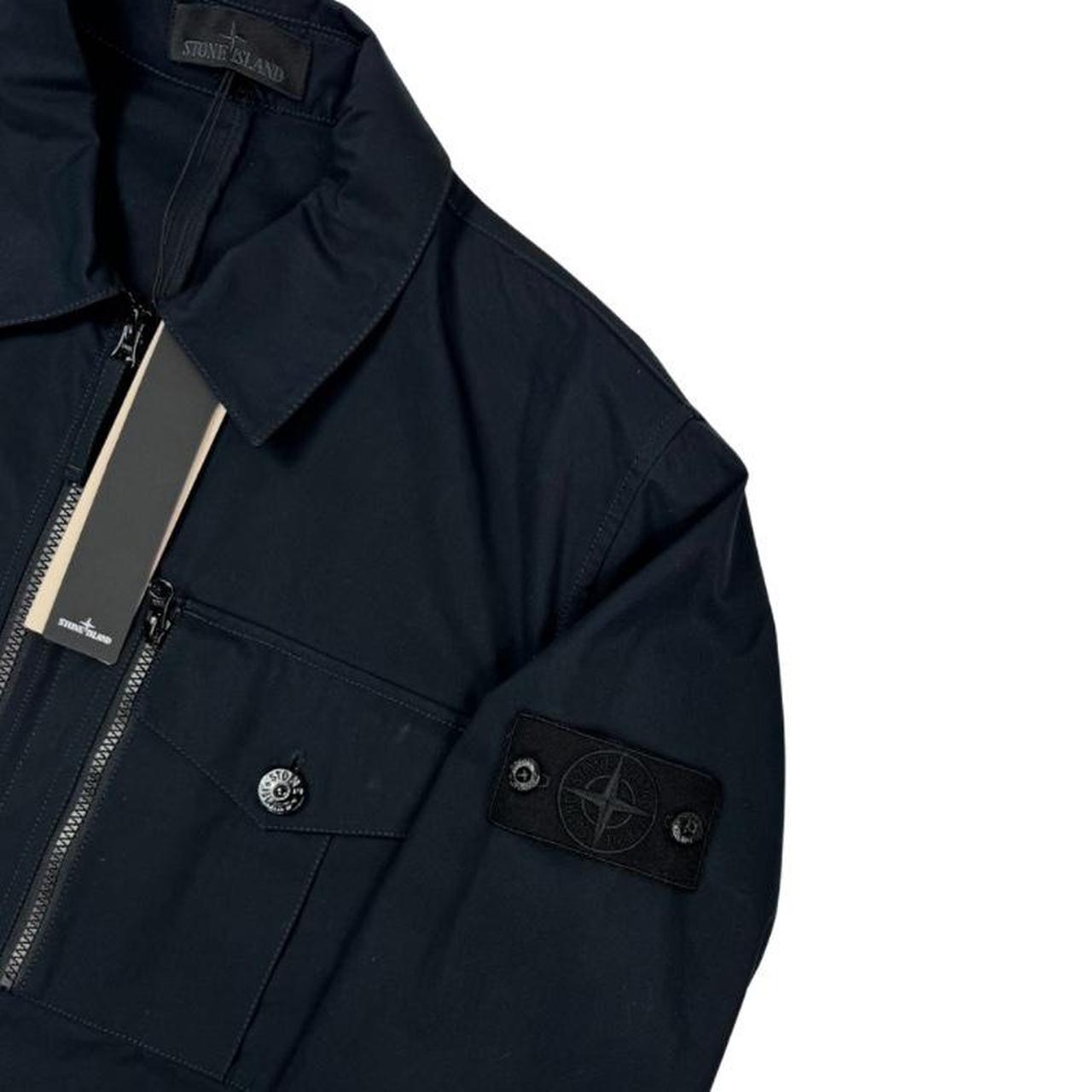 Stone Island navy blue waterproof overshirt jacket with ghost logo and cotton material.