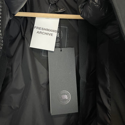 Canada Goose black parka with fur trim, logo patch, and down insulation.