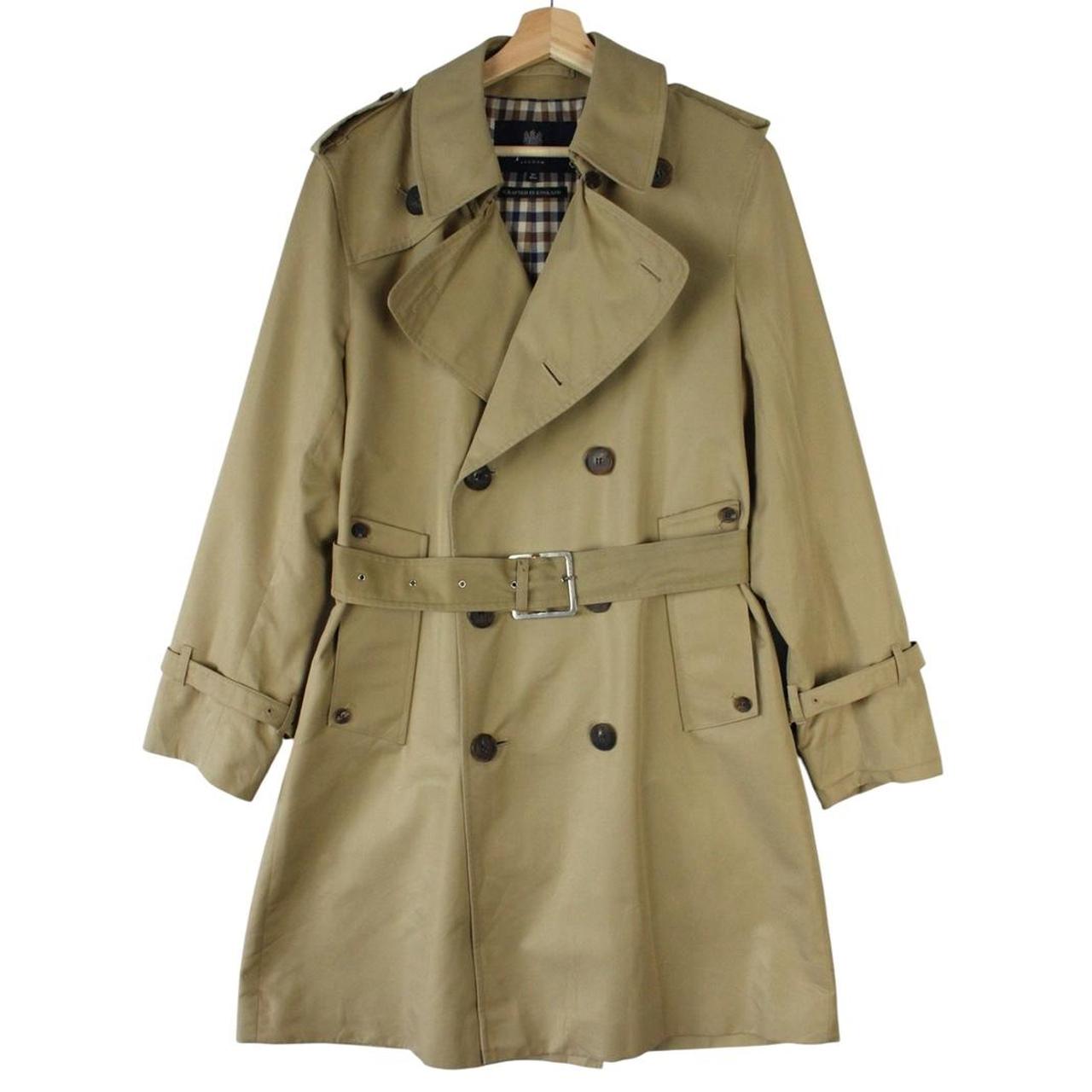 Aquascutum tan brown double breasted trench coat with house check pattern and belted waist.