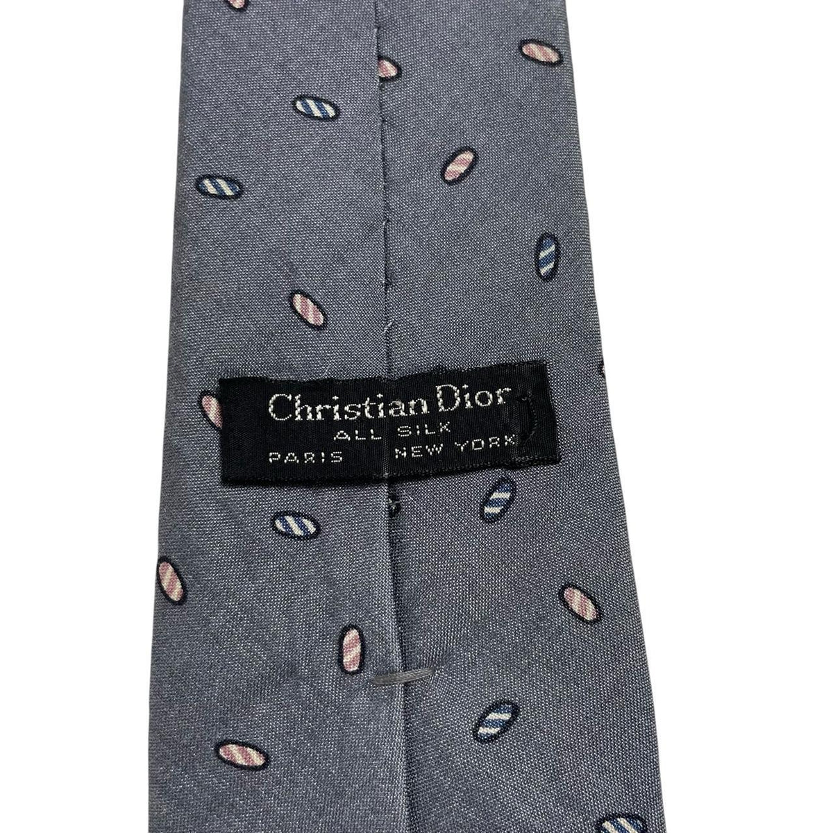Christian Dior grey silk tie with abstract print and logo detail.