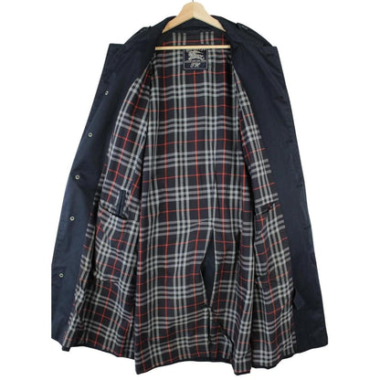 Burberry navy blue trench coat with belted waist and single breasted design.