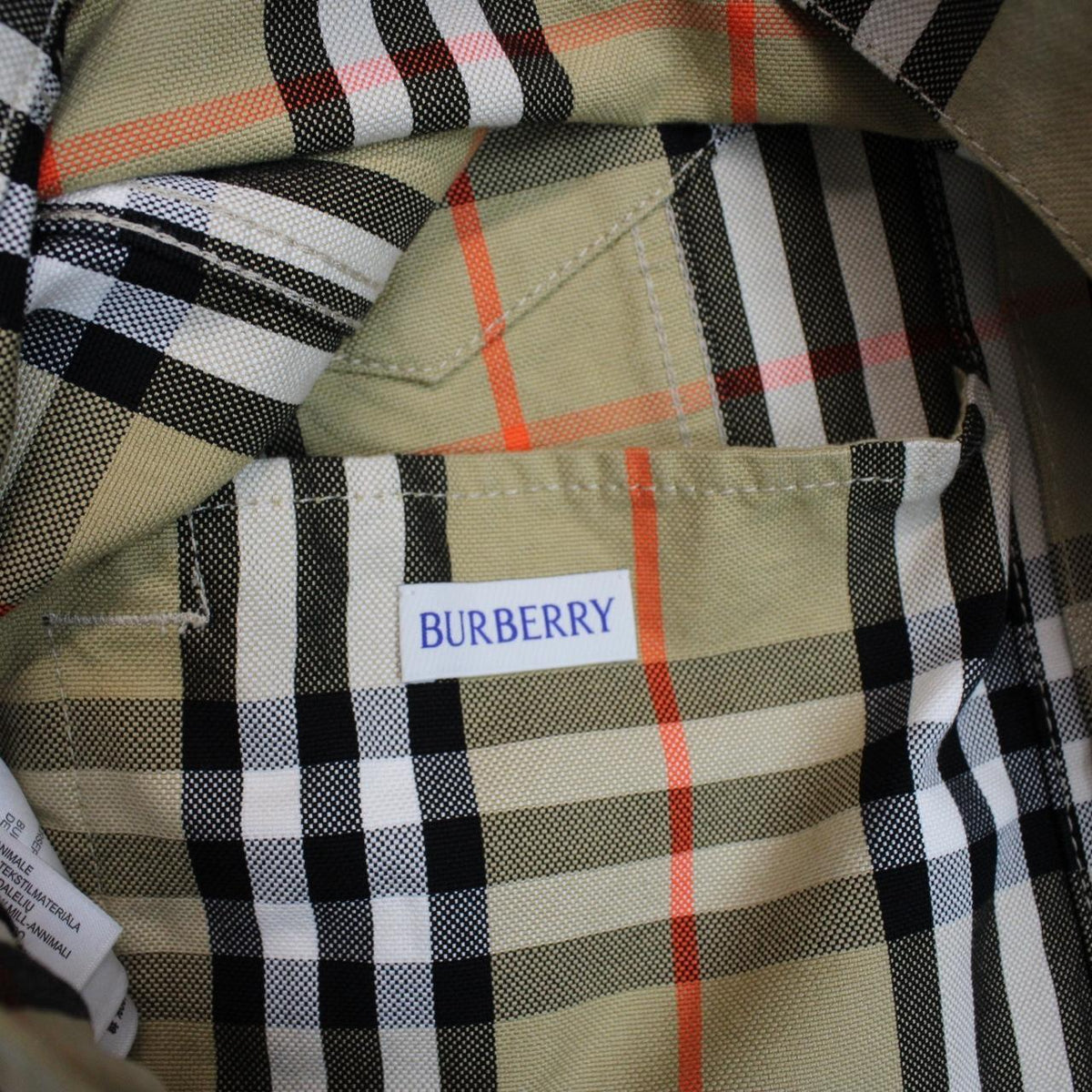 Burberry beige denim jacket featuring iconic Nova Check pattern and logo detail.