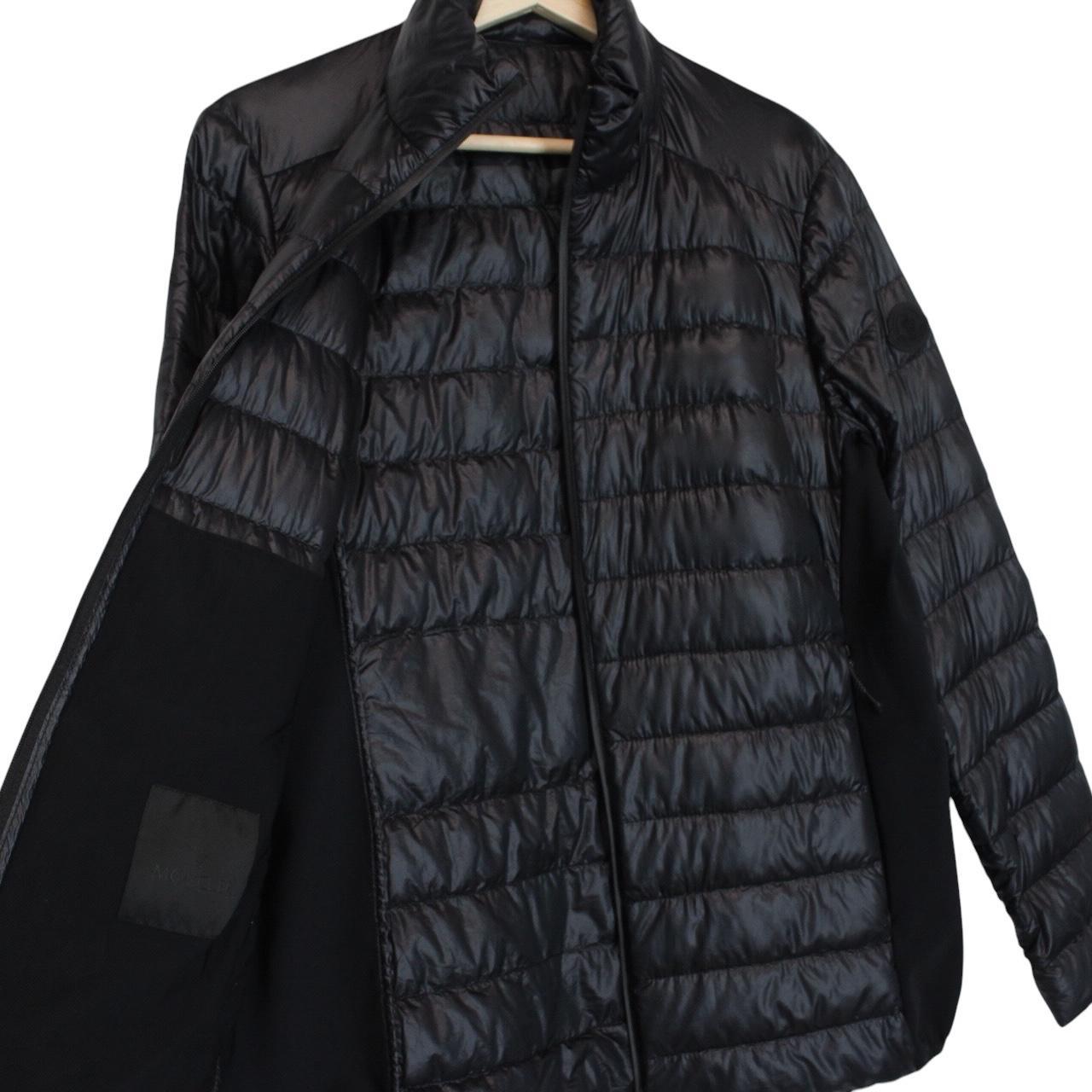 Moncler black lightweight down jacket with full zip and logo patch on sleeve.