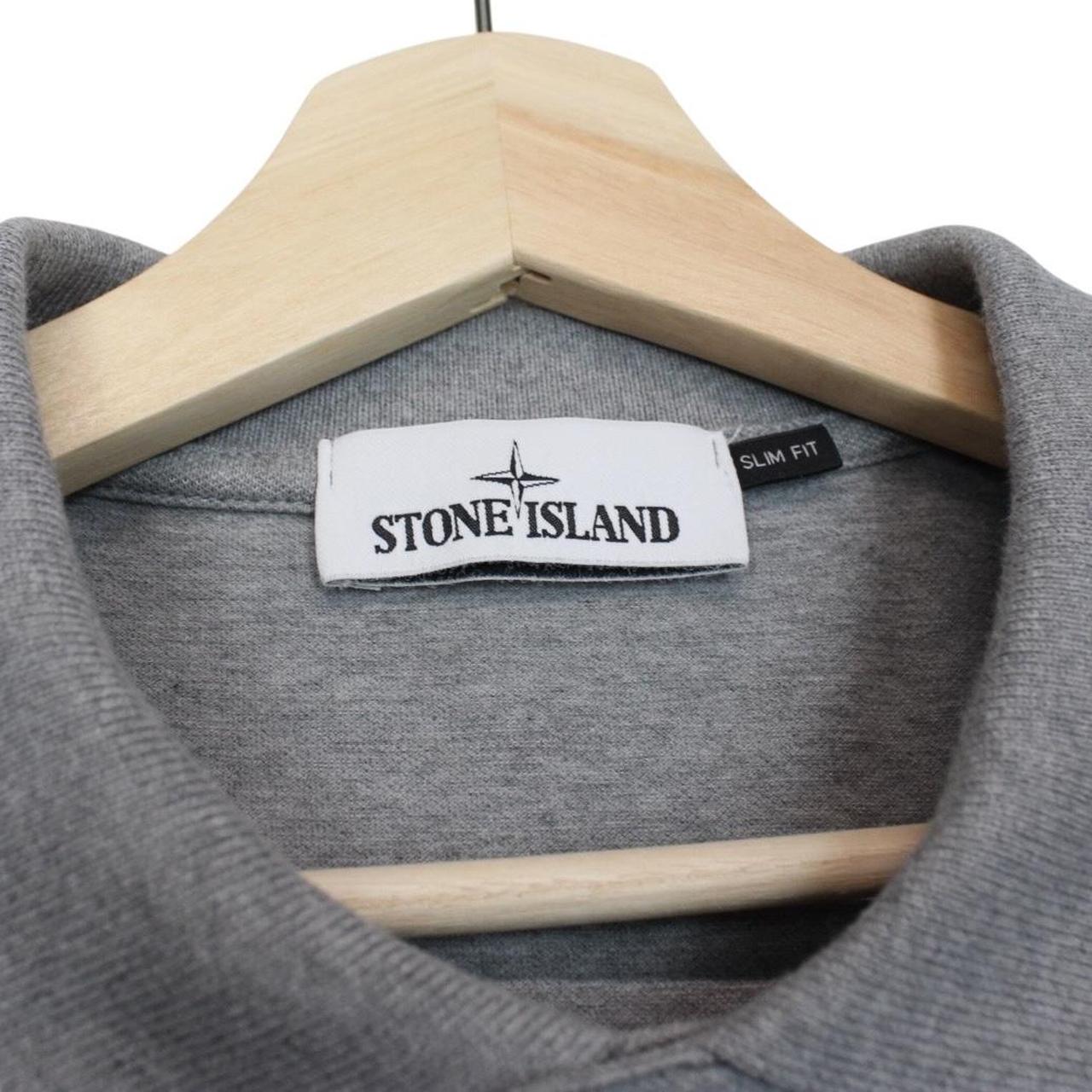 Stone Island grey polo shirt with embroidered compass logo and cotton material.