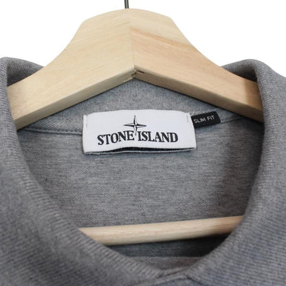 Stone Island grey polo shirt with embroidered compass logo and cotton material.