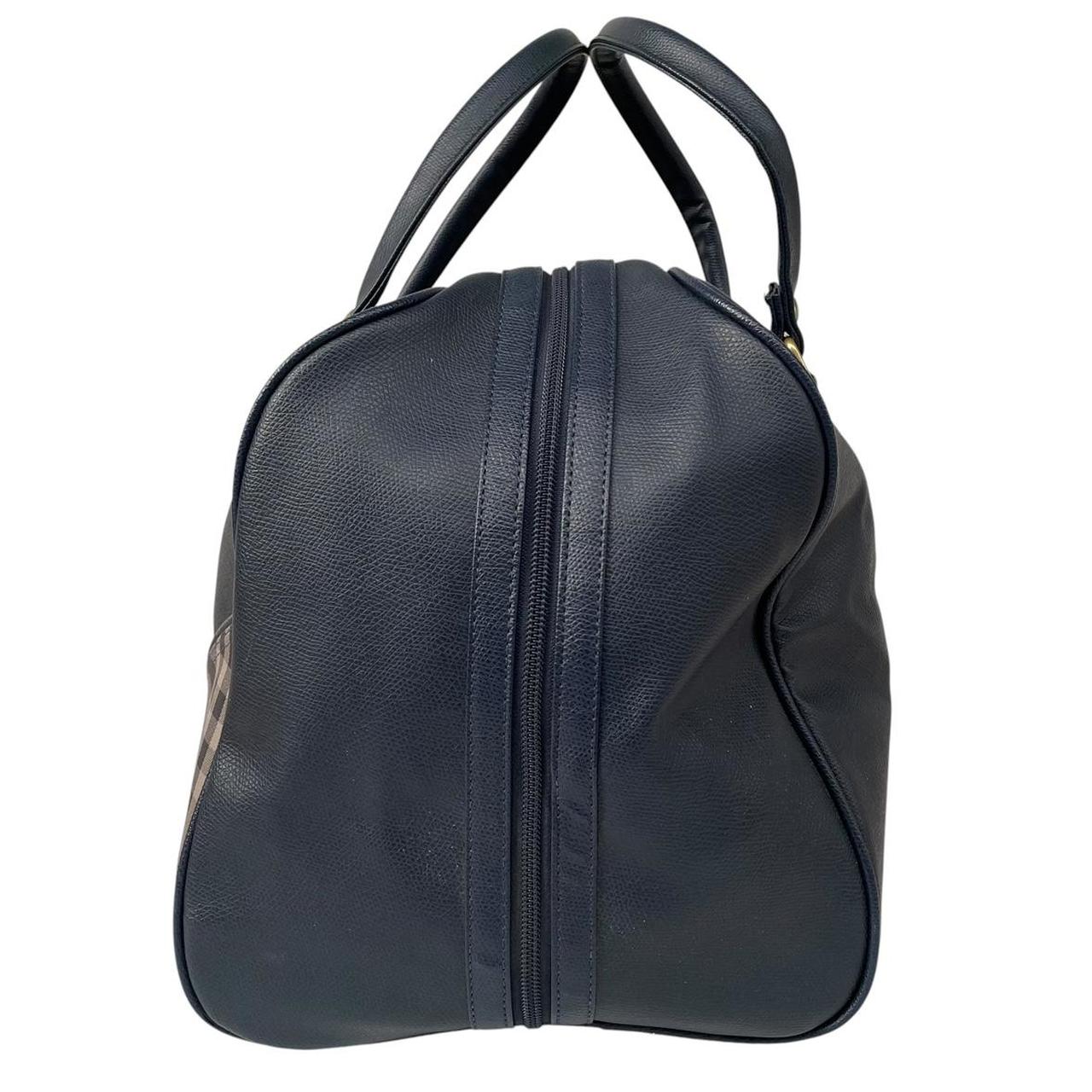Burberry navy blue duffel bag featuring iconic Nova Check pattern and leather accents.