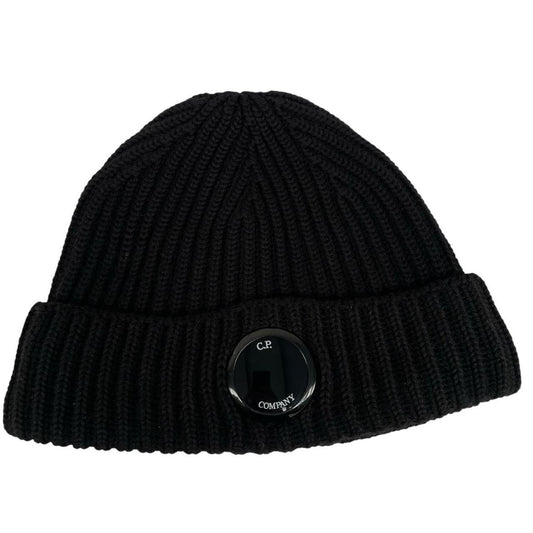 CP Company black wool knit beanie hat with signature lens detail.
