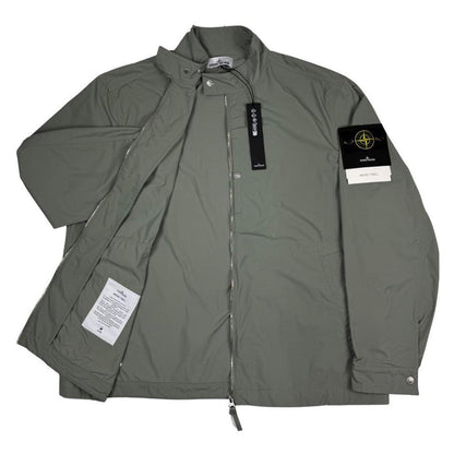Stone Island green full zip jacket with logo patch and micro twill fabric.
