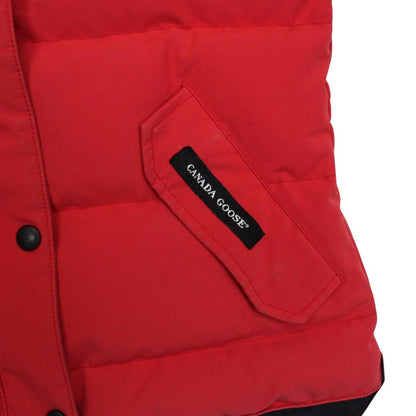 Canada Goose red down gilet with logo patch and zippered pockets.