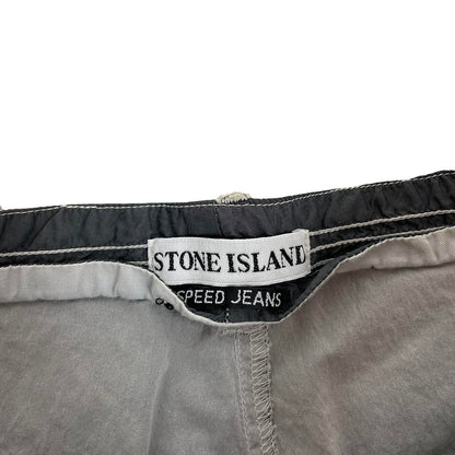 Stone Island grey tapered fit trousers with logo patch and cotton material.