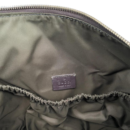 Gucci brown diaper changing bag with Supreme GG monogram and leather shoulder strap.