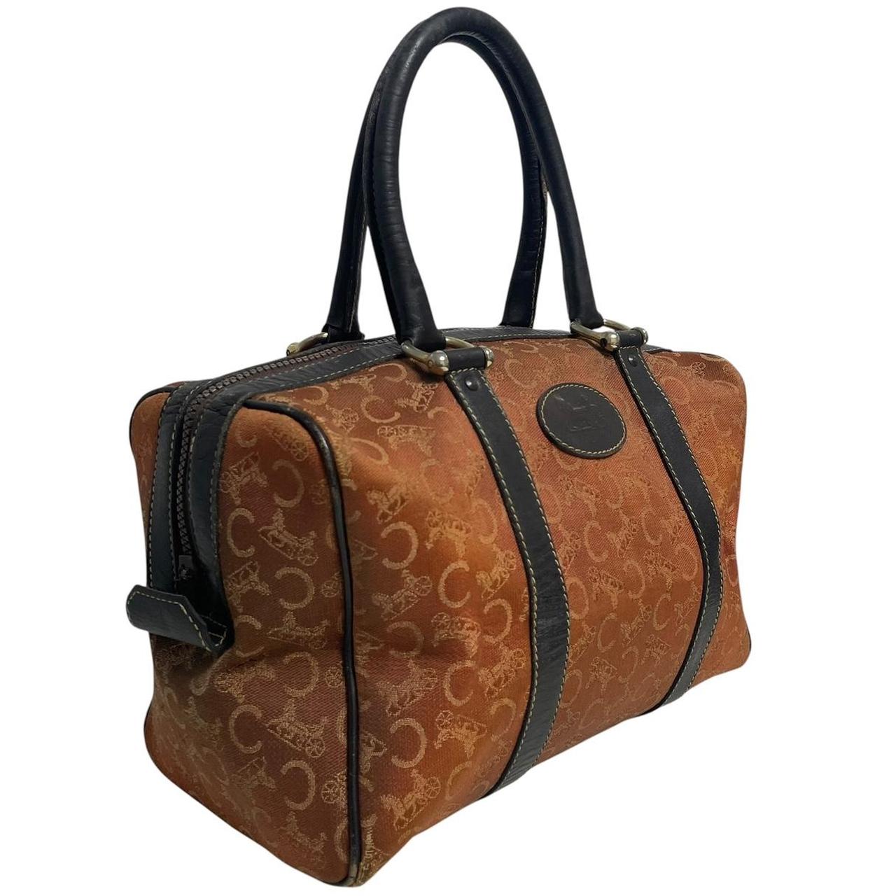 CELINE orange duffel bag with Macadam canvas and leather, visible wear and discolouration.