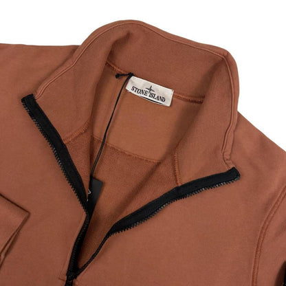Stone Island orange jumper with 1/4 zip, logo patch on sleeve, organic cotton.