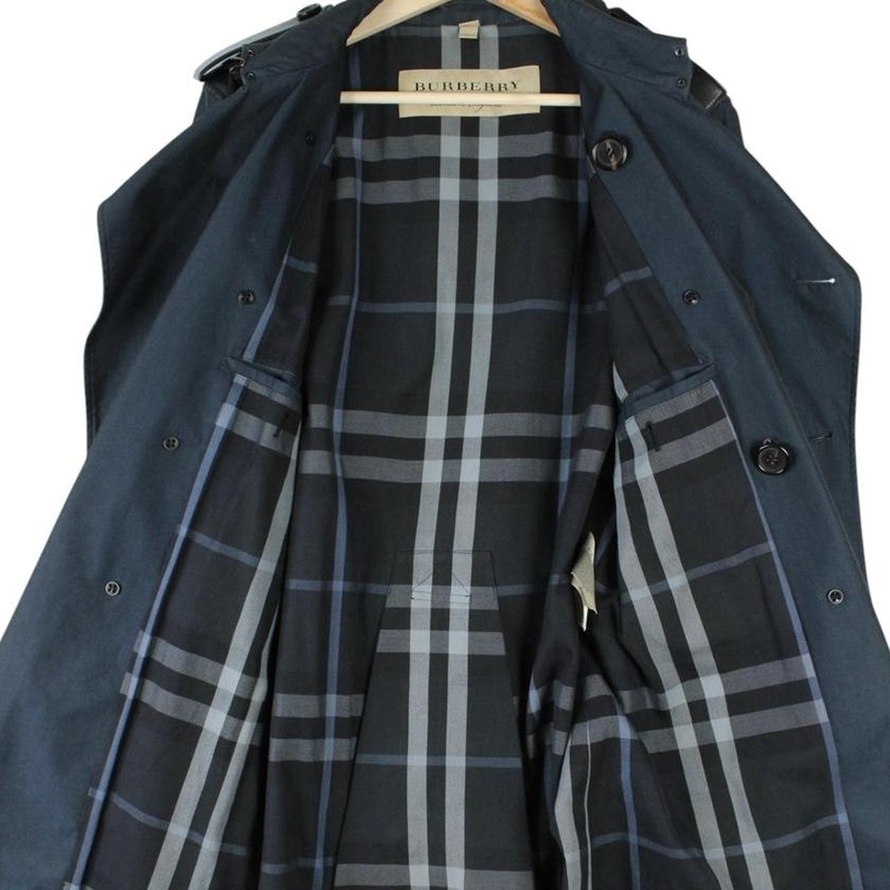 Burberry navy blue trench coat with Nova Check pattern and double-breasted design.