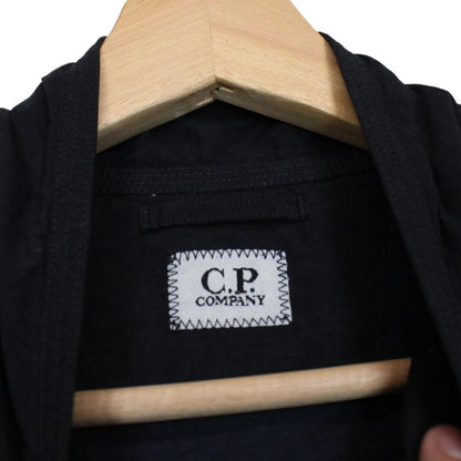 CP Company navy blue jacket 1/4 zip with lens detail and flat nylon material.