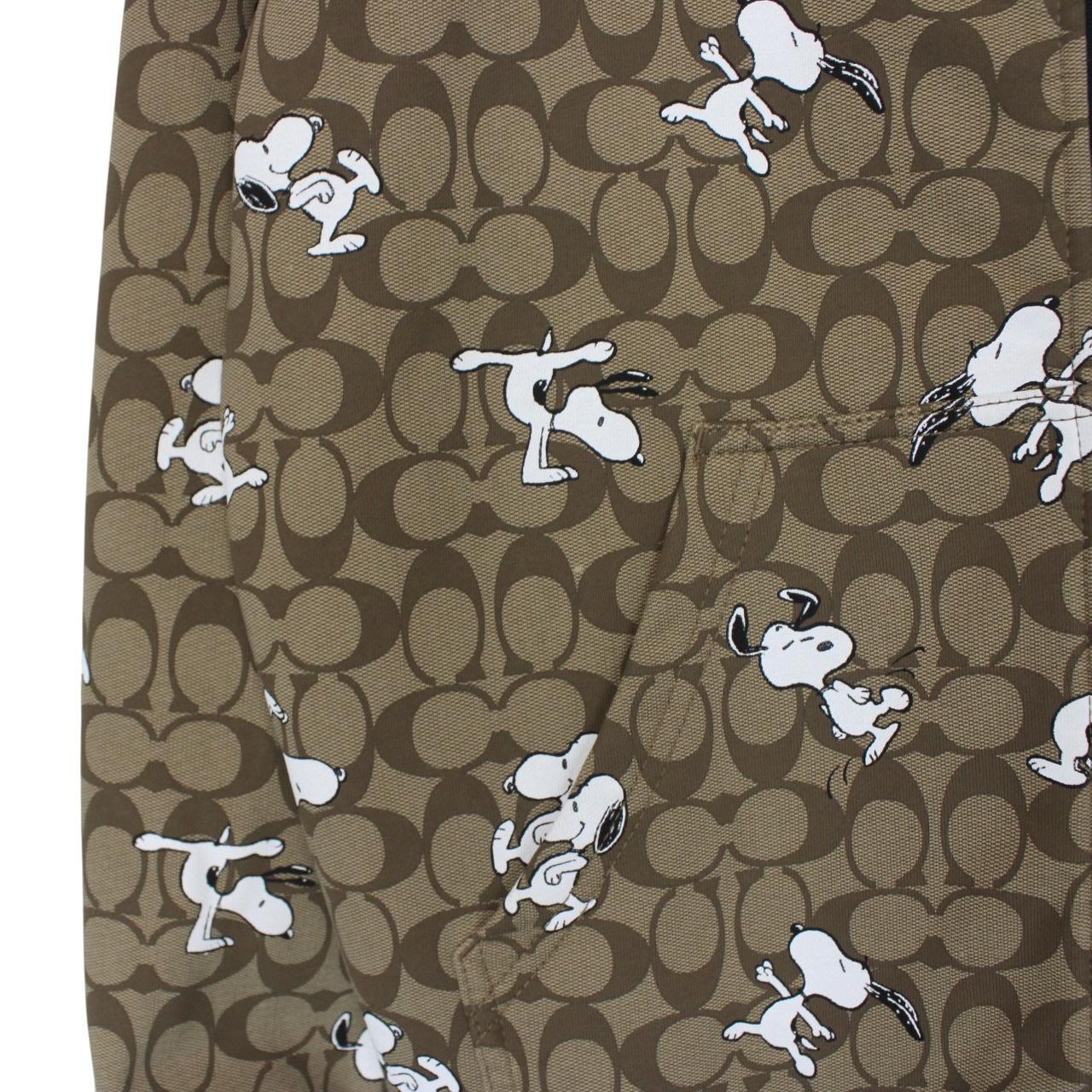 Coach brown hoodie featuring Peanuts Snoopy graphic and full zip design.