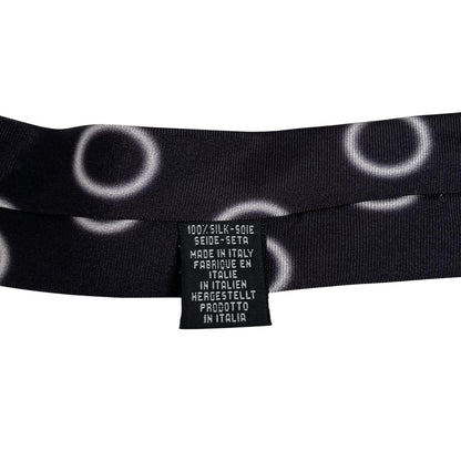 Paul Smith black and white silk tie with circular print and square cut design.