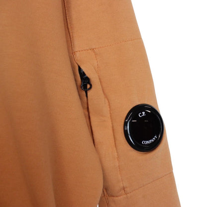 CP Company orange sweatshirt featuring goggle lens detail and soft cotton material.