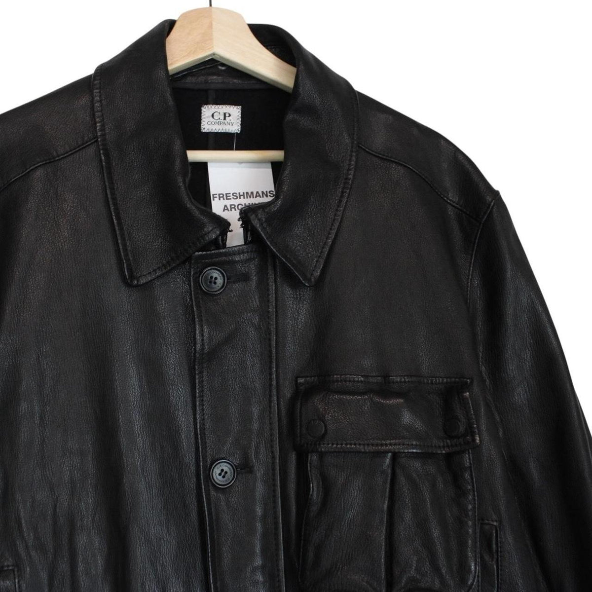 CP Company black leather jacket with multi pockets and logo detail.