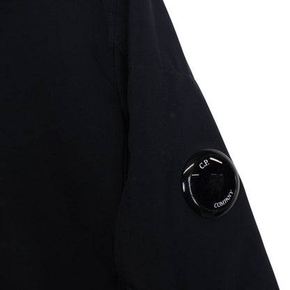 CP Company navy blue goggle jacket with full zip and soft shell material.
