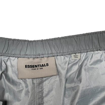 Essentials silver reflective nylon shorts with logo detail and sleek design.
