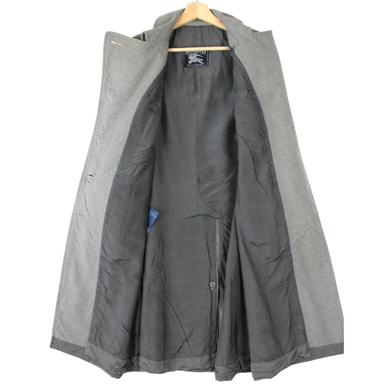 Burberry grey double breasted wool trench coat with classic check lining and logo buttons.
