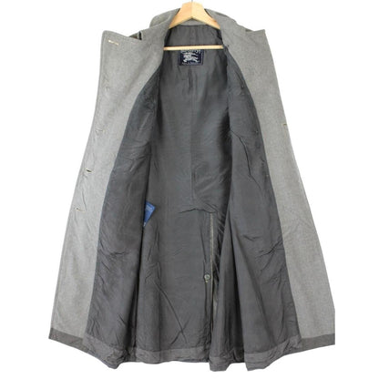 Burberry grey double breasted wool trench coat with classic check lining and logo buttons.