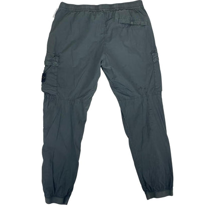 Stone Island grey cargo trousers with logo patch and loose stitch detail.