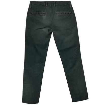 Stone Island green slim fit cotton trousers with logo patch and faded details.