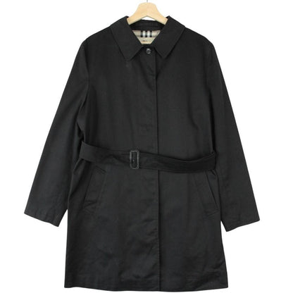 Burberry black trench coat with Nova Check pattern and belted waist in cotton.