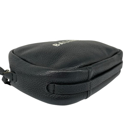 Balenciaga black leather messenger bag with embossed logo and minimalistic design.