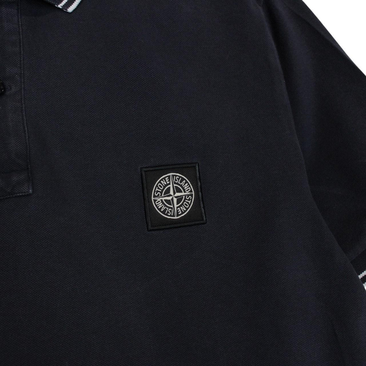 Stone Island navy blue short sleeve polo shirt with compass logo and cotton material.