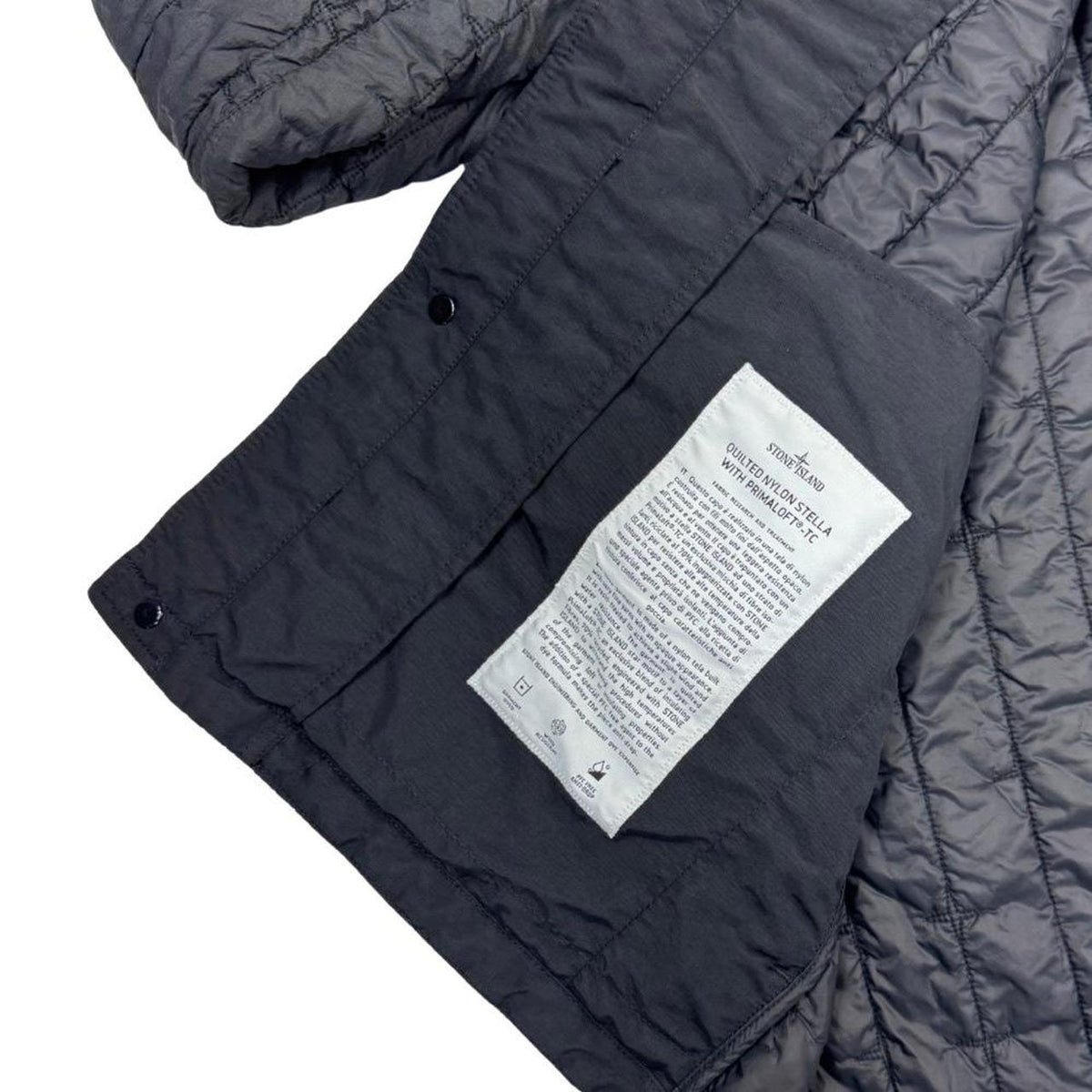 Stone Island black quilted nylon jacket with logo badge and Primaloft-TC material.