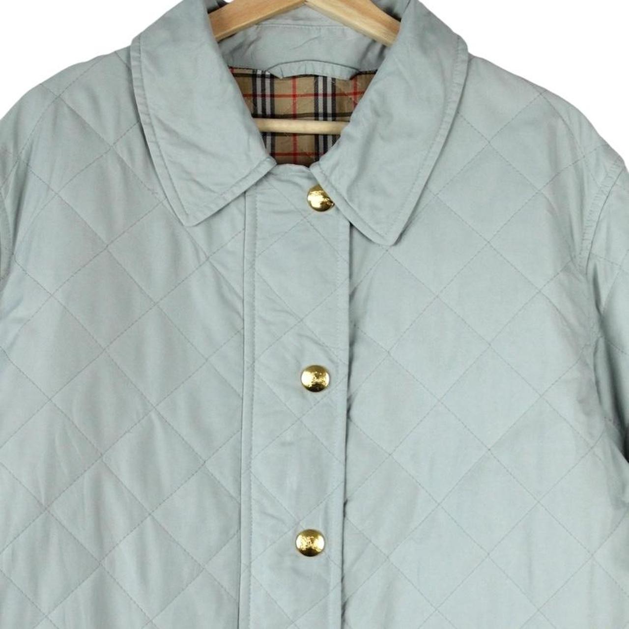 Burberry light blue diamond quilted jacket with Nova Check pattern and logo detail.
